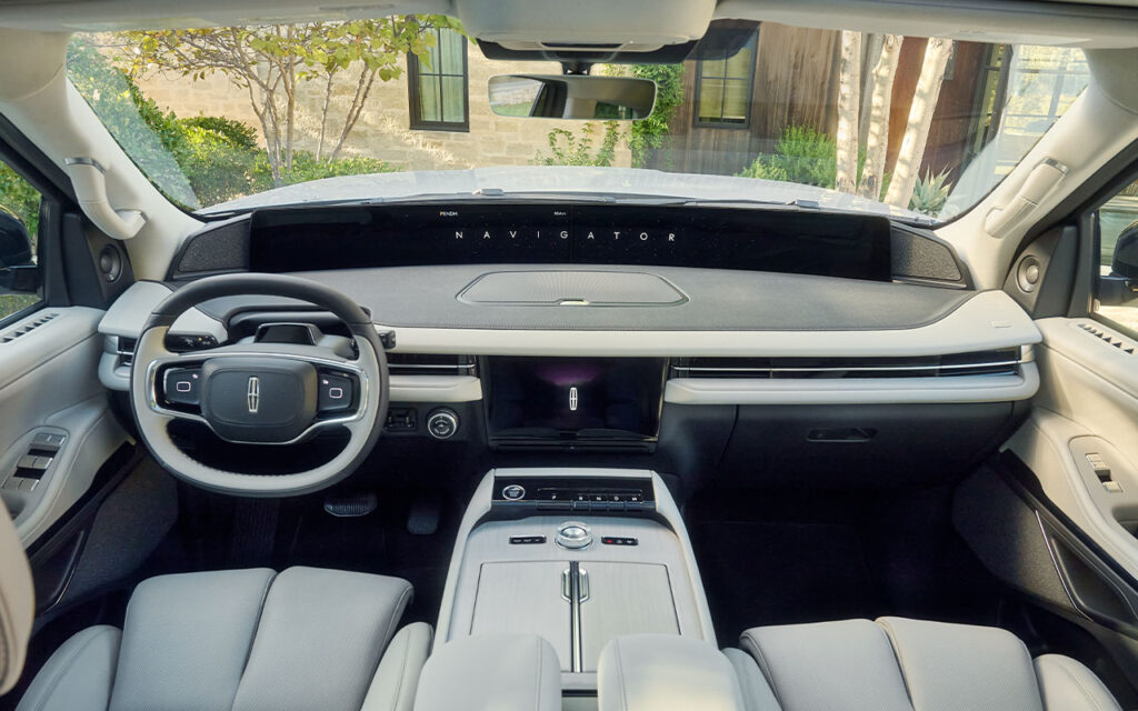 Luxury SUV interior with modern dashboard, sleek steering wheel, and advanced controls.
